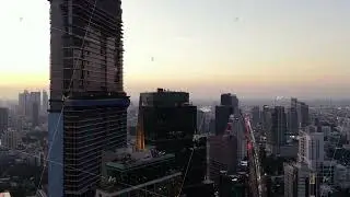 Aerial view of Bangkok's financial district at sunset. Modern skyline features impressive