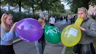 Girls blowing balloons at public Festival (Part 5) (Preview)