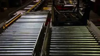 Cylinder operated pop up locators and chain transfer