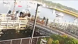 Truck reverses off of Marshfield, MA dock into water and nearly misses a boat