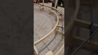 Curved bench assembly, 1 of 3. Curved bench in production showing clamping and glueing