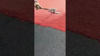 Installing Red and Black Granulated Rubber Safety Flooring Carefully.