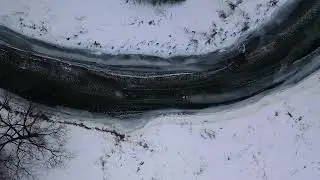 Arctic Elegance: Aerial Glimpse of a Frozen River's Winter Tapestry ❄️🌊🚁