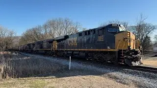 CSX empty northbound grain train with a trio of website GE locomotives leading through Cowan 