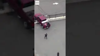 WILD CHASE: Massachusetts police approach truck with guns drawn before it smashes through fence