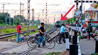 Freight train passing through a very busy railgate : indian Railways level crossing