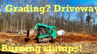 Putting in a DRIVEWAY, grading BACKYARD and burning STUMPS.