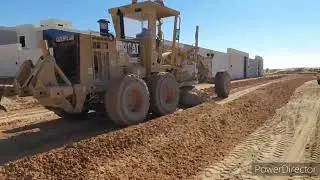 Heavy equipment Cat grader mixing and leveling /DrewTV