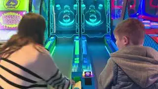 Zach has fun at Skeeball and scores!!
