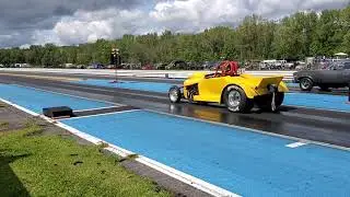 My uncle drag racing a yellow roadster