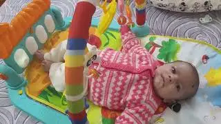 3 months Baby playing in gym bed