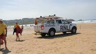 Humans lie stranded on a beach awaiting tide to carry them off.
