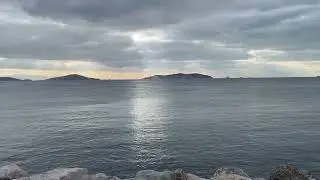 Black Dark Clouds, Dark Blue Sea , Brilliant Light Beams Over Each Princess Islands 