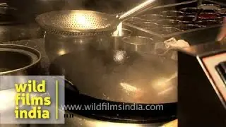 Chef preparing Chinese dish at kitchen of Hyatt Regency, Delhi