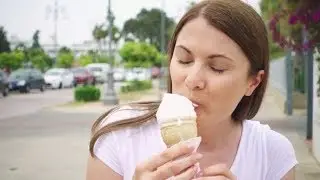 Woman Enjoying Soft Ice Cream Cone Outdoors. Female Traveler Eating Frozen Yogurt on Street Alone |