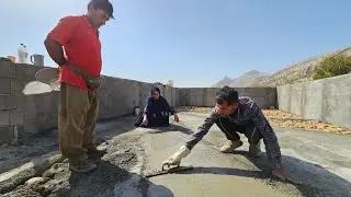 Pool construction: Concreting half of the pool floor with the help of a master builder