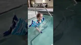 4 year old girl swimming with arm floaties