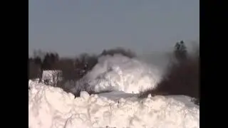 Train plows through snow bank