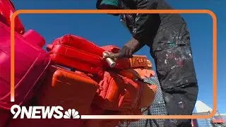 New sculpture made from upcycled luggage being installed at DIA