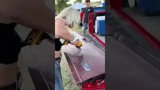 Signing a tail gate with an angle grinder,