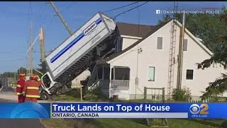 Watch: Moving Truck Somehow Ends Up With Rear Wheels On House