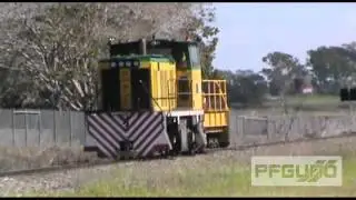 Cane Train And Trailer Going Through Rail Crossing [SD]