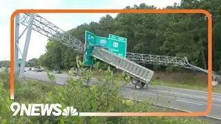 RAW: Bed of truck somehow gets stuck on overhead sign