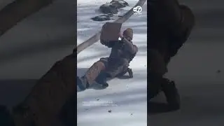 UPS driver slides down ice-covered driveway to deliver parcel