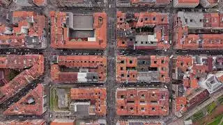 Aerial top down perspective flying over typical red rooftops and streets of Bilbao, Spain, capturing