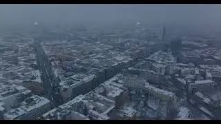 Aerial panoramic footage of winter city. Urban neighbourhood with buildings sprinkled with