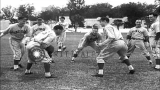 The players of the Cincinnati Reds baseball team practice pitching and roll on a ...HD Stock Footage