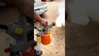 Mosquito fogging machine releasing smoke for pest control.