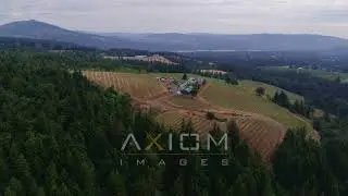 6K drone aerial video of a wide angle orbit of winery with mountains in background.. | DX0001_000330