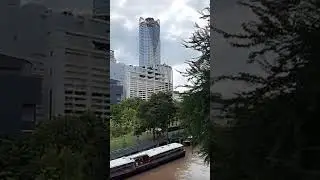 A long ferry parked in a river at the downtown city of Bangkok (Thailand)