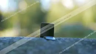 Smart Watch is on a large stone in the street. Moving the camera