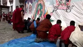 Monks folding the Thangkha displayed at Kurjey Festival in Bamthang