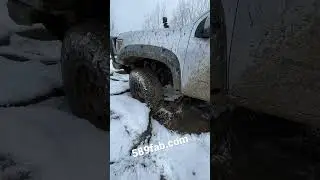 Extended cab short bed Colorado on the snowy rocks.