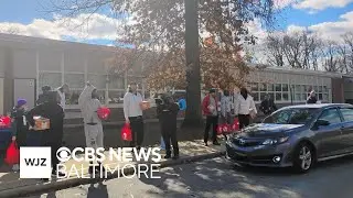 Baltimore Ravens go into the community to hand Thanksgiving turkeys to families