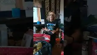 Man opens Christmas presents 25/12/23