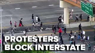 Large group of protesters temporarily close down I-630 in Little Rock