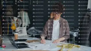 Creative lady designer sketching drawing clothes working in modern studio