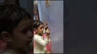 Sona ma drawing on her blue baari wall and board