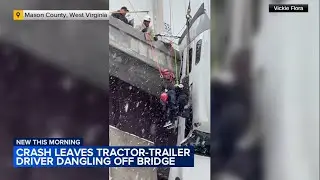 Tractor-trailer driver rescued from cab dangling off bridge in West Virginia