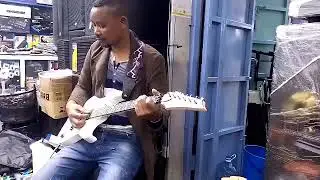 ADAM MALOMBE KYALYA TESTING HIS NEW GUITER GIFTED BY HIS FRIEND KILONZO AT NICKLIGHT ELECTRONIC NRB