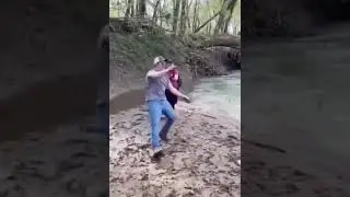 man slips in mud but busts a move instead