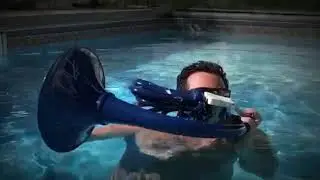 Swimming while playing a plastic French Horn?!