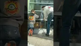 Installing anti graffiti film onto coffee shop windows in boston