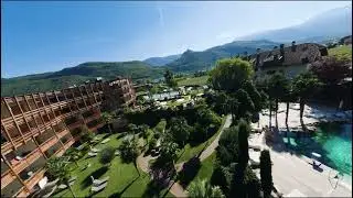 Breathtaking FPV drone ride over hotel pools and park at Lake Caldaro
