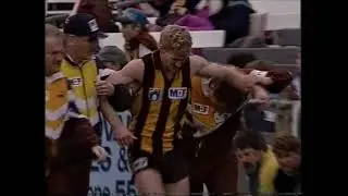 Shayne Stevenson kicks a goal on a broken leg