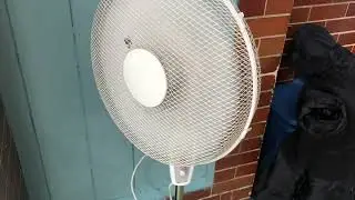 A worn out and tatty Argos value range 16&rdquo; pedestal fan at my local community hall